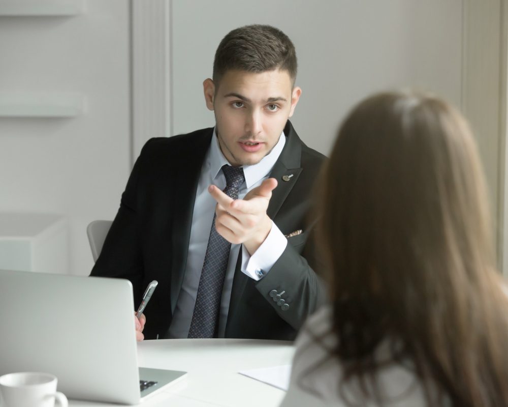 two-business-people-talking-at-the-office-desk.jpg